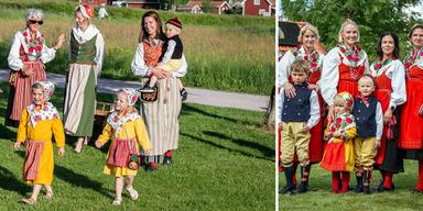Människor i folkdräkt vid midsommarfiranden.
